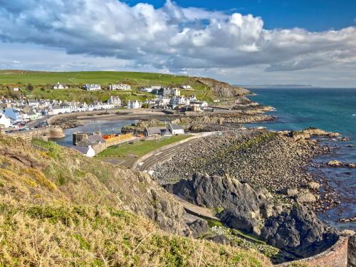 a small town on the coast of the ocean at Farmhouse in Dunragit