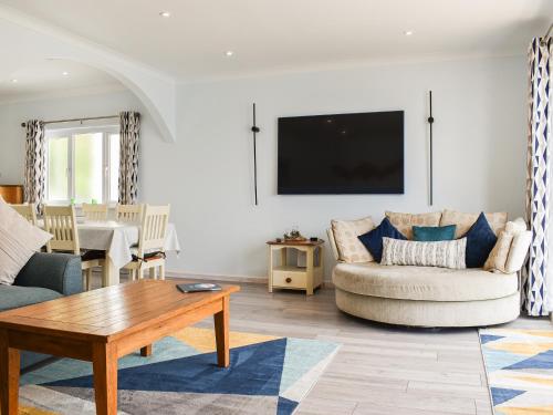 a living room with a couch and a table at The Dawn in Looe