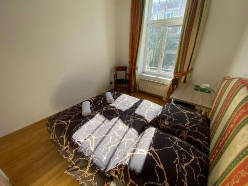 a bed in a small room with a window at Fantastic-Inn Warszawa - CH30 in Warsaw