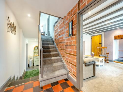 a brick wall in a hallway with a staircase at Park Clement in Clydey
