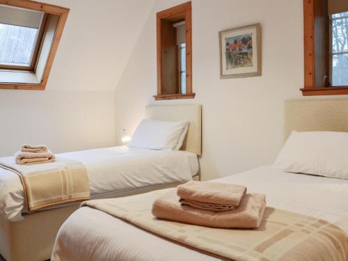 a room with two beds with towels on them at The Stable-Uk41650 in Blairgowrie
