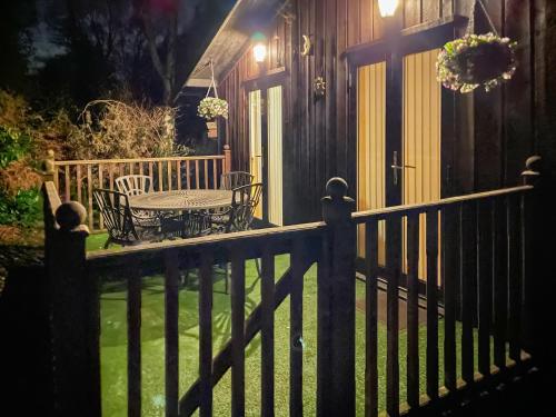 a porch of a house with a table and chairs at The Hive in Warmwell