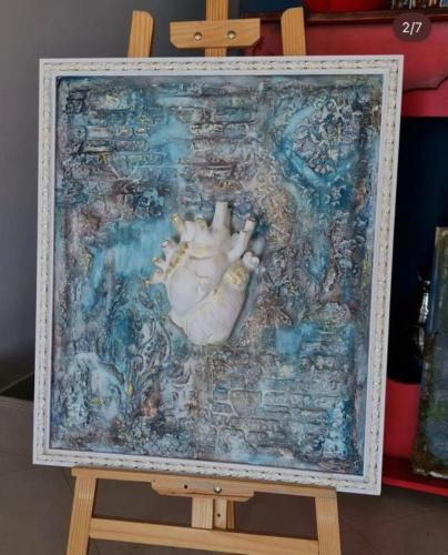 a picture of a painting of a baby on a table at NovART Gallery & Sea Hotel in Sumqayyt