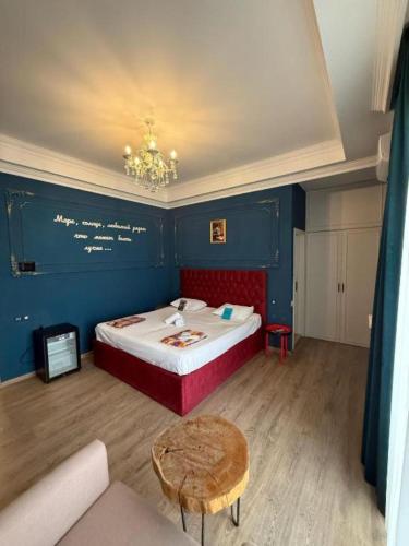 a room with a bed and a table in it at NovART Gallery & Sea Hotel in Sumqayyt