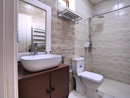 a bathroom with a sink and a toilet and a shower at NovART Gallery & Sea Hotel in Sumqayyt