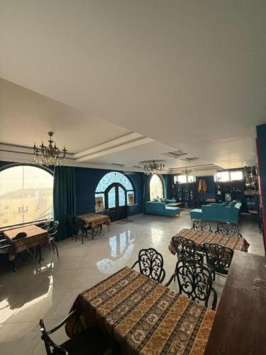 a large room with tables and chairs in a building at NovART Gallery & Sea Hotel in Sumqayyt