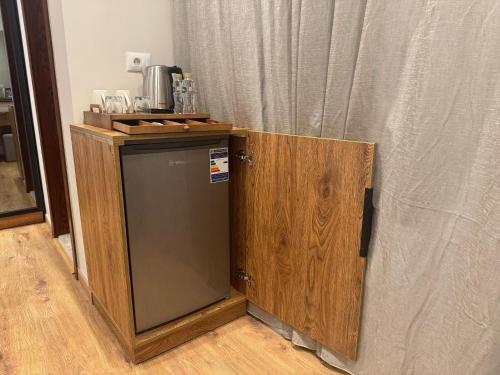 a small refrigerator in a room with a curtain at Palacio Pyramids Hotel in Cairo