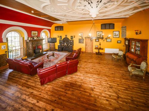 a large living room with couches and a fireplace at The Auction House in Criccieth