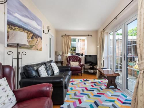 a living room with a couch and a table at Holly-Garth in Helmsley