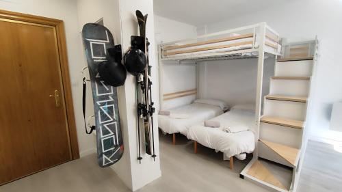 a room with three bunk beds and a ladder at Estudio vistas al Veleta Parking Gratis in Monachil