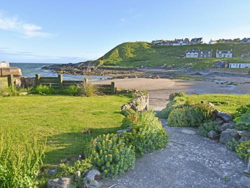 a view of a beach with a grassy field at The Cliff in Ellon