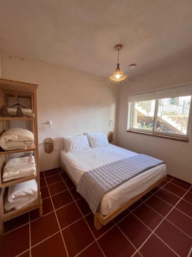 a bedroom with a large bed and a window at טרקוטה in Odem