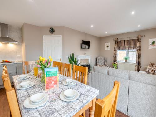 a dining room and kitchen with a table and chairs at Cherry Blossom - Uk48837 in Skegness
