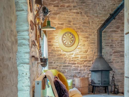 a living room with a brick wall and a stove at Upper House - Uk48805 in Hereford