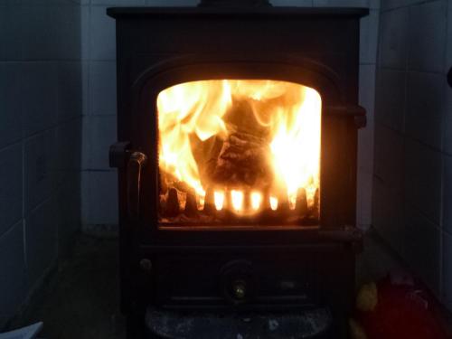 a stove with a fire inside of it at Southview in Porchfield