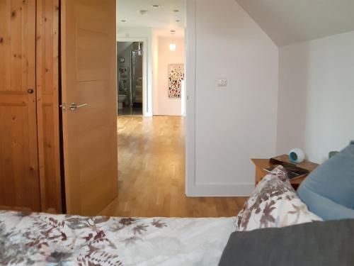 a living room with a bed and a hallway at The Fold in Appleton
