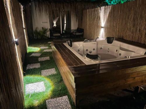 a large bath tub in a room with grass at Kiriş Garden Hotel in Kemer