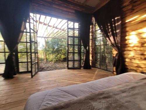 a bedroom with a bed in a room with windows at DesertDewEstate in Nanyuki