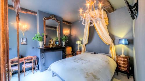 a bedroom with a bed and a mirror and a chandelier at Mons Dragon House in Mons