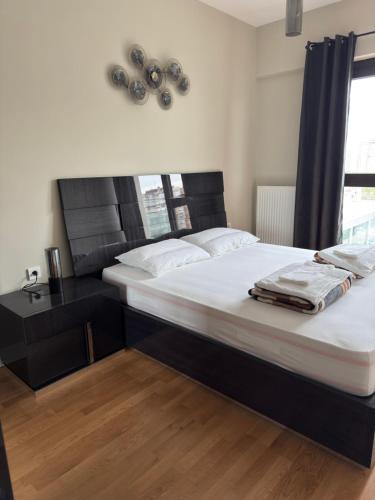 a bedroom with two beds and a desk and a window at Luxury Apartment 52 Diamond Residences in Skopje