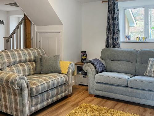 a living room with two chairs and a couch at The Barn in Llangwm