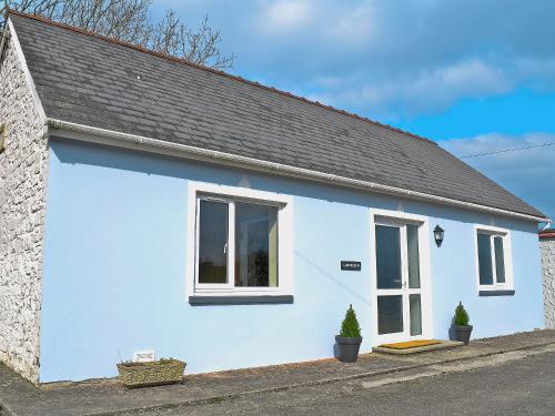 a white house with a black roof at Llwynbedw - 28464 in Cardigan