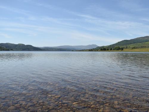 a large body of water with mountains in the background at Hazel - Apartment in Aberfoyle