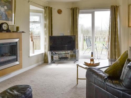 a living room with a couch and a television at Willow in Thornbury
