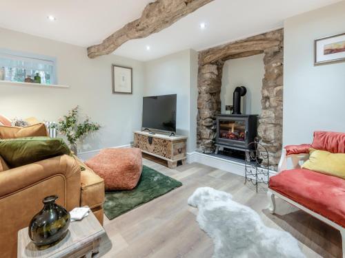a dog in a living room with a fireplace at The Nook - Uk44735 in Tallentire