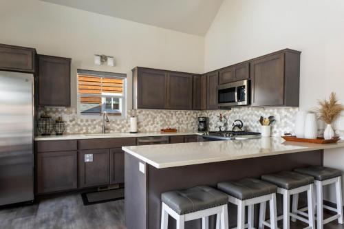 a kitchen with wooden cabinets and a counter with bar stools at 20 Pomrankey Ln in Dover