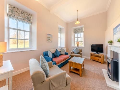 a living room with a couch and a tv at The Old Bakery - Uk48319 in Berwick-Upon-Tweed