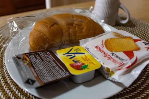 a sandwich and a loaf of bread on a plate at B&B San Savino in Piacenza
