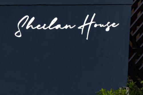 a sign for a hilhan huble sign on a building at Sheilan House in Port Alfred