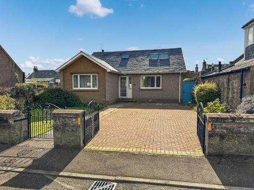 a house with a gate and a brick driveway at Bents Retreat in Montrose