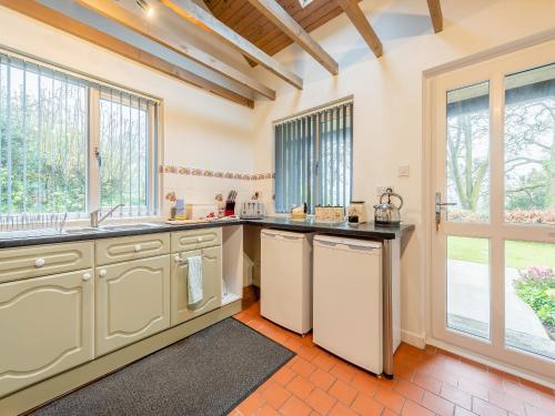 a kitchen with a sink and a dishwasher at Rhydyfran Coach House in Cribyn