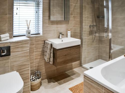 a bathroom with a sink and a shower at Lyndhurst in Longhorsley