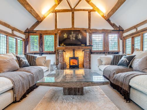 a living room with two couches and a fireplace at Waterside House in Knaresborough