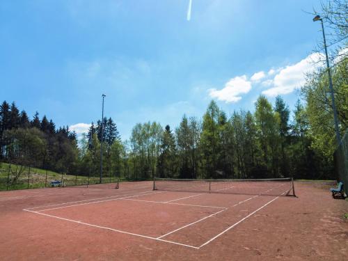 a tennis court with a net on top of it at Group Escape in Mellier in Mellier
