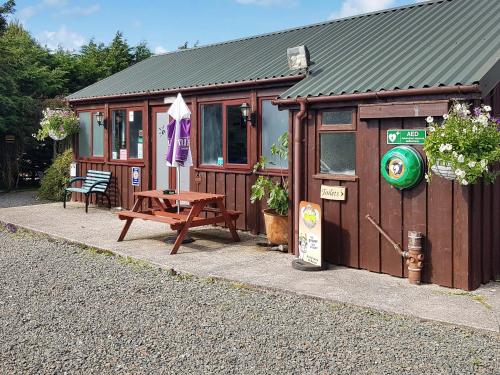 a small cabin with a picnic table in front of it at Acacia in Thornbury