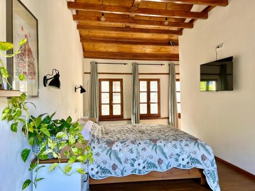 a bedroom with a bed and a wooden ceiling at Our Townhouse in Gjirokastër