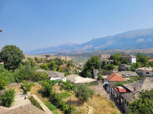a view of a village with mountains in the background at Guri Guesthouse in Gjirokastër