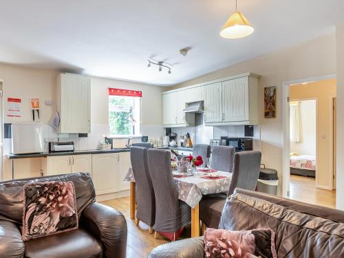 a kitchen and living room with a table and chairs at Primrose - W43303 in Goxhill