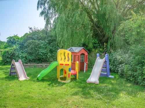 a group of childrens playground equipment in the grass at Primrose - W43303 in Goxhill