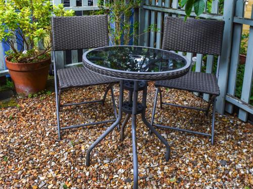 two chairs and a glass table and chairs at Cooperative Cottage - Uk44502 in Saddleworth