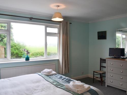 a bedroom with a bed and a window at Glebe Farm Bungalow in Market Rasen