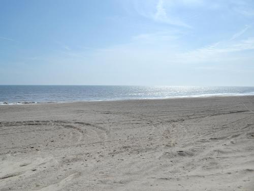 an empty beach with footprints in the sand at Glebe Farm Bungalow in Market Rasen