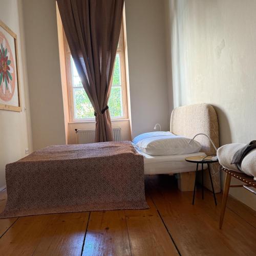a bedroom with a bed and a window at Palais am Park in Krems an der Donau