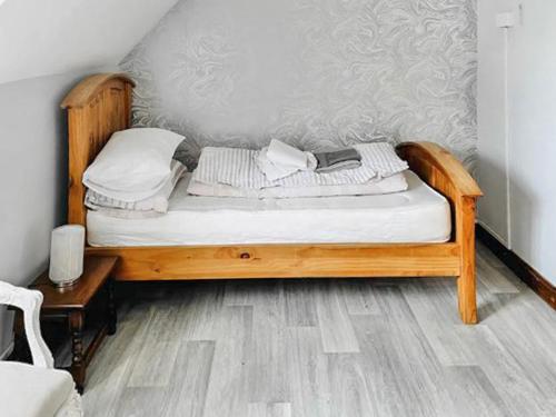 a bed with a wooden frame in a room at Grantham House in Grantham
