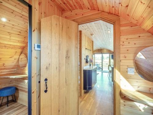 a room with wooden walls and a door in a house at Primrose - Uk42358 in Saint Harmon