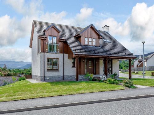 a house with a shingled roof on a street at The Lookout in Aviemore